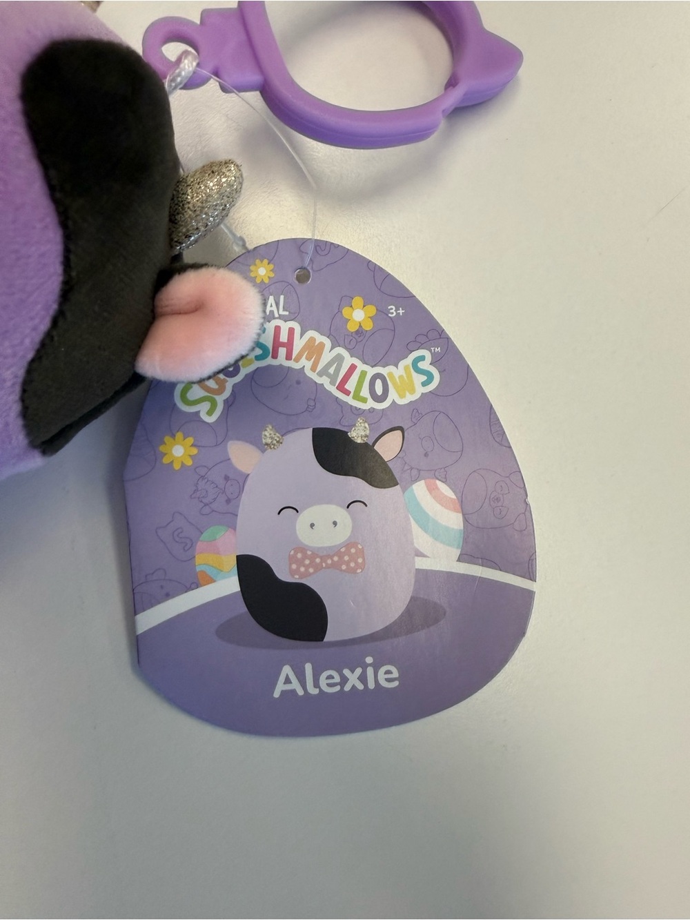 NWT 4 inch Alexie the Cow Squishmallow Purple Easter Clip-On Plush Toy - Picture 3 of 4